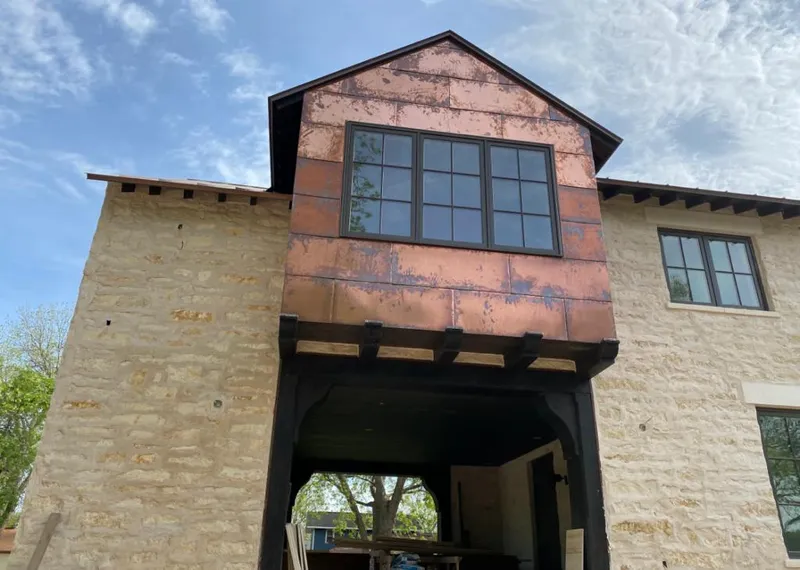 Copper metal panel facade on a stone building for Metal Roof Coating in West Point